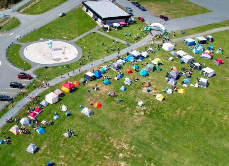 A city park lined with tents. 