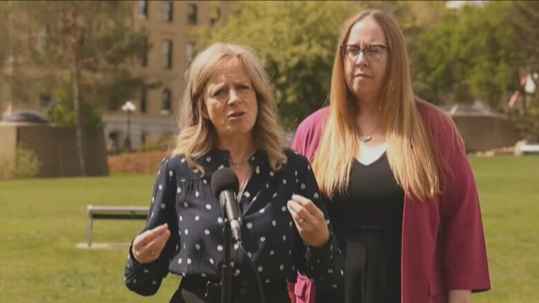 NDP Leader Rachel Notley was joined by NDP house leader Christina Gray at a news conference with the Alberta legislature in the background. 