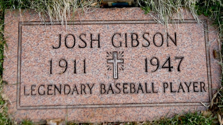 A gravestone is shown that reads Josh Gibson, legendary baseball player, 1911 to 1947.