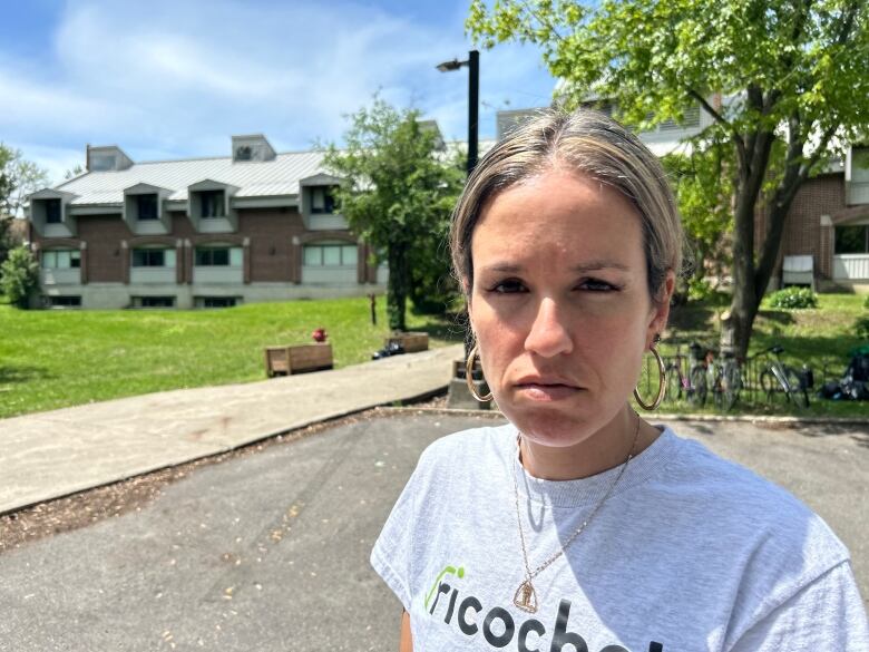 A woman in grey tee with the words 