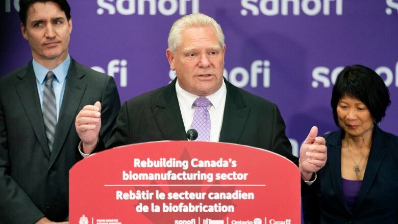 Ontario Premier Doug Ford, centre, delivers remarks while flanked by Prime Minister Justin Trudeau, left, and Toronto Mayor Olivia Chow, right, during a news conference in Toronto on May 30, 2024.