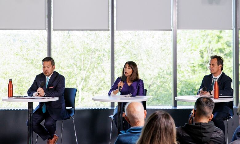 Mississauga mayoral candidates Dipika Damerla, centre, Stephen Dasko, right, and Alvin Tedjo, left, take part in a live debate hosted by the CBCs David Common, at the Living Arts Centre, on May 30, 2024.