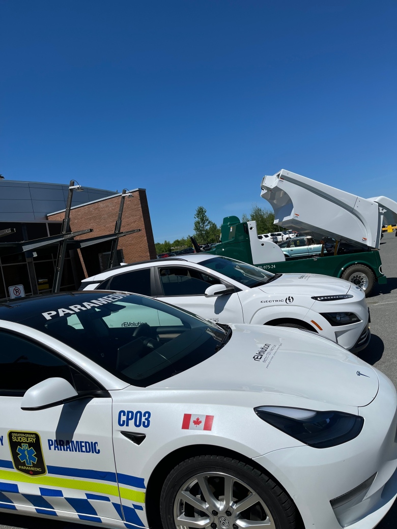 Two white cars and a dump truck in the background. 