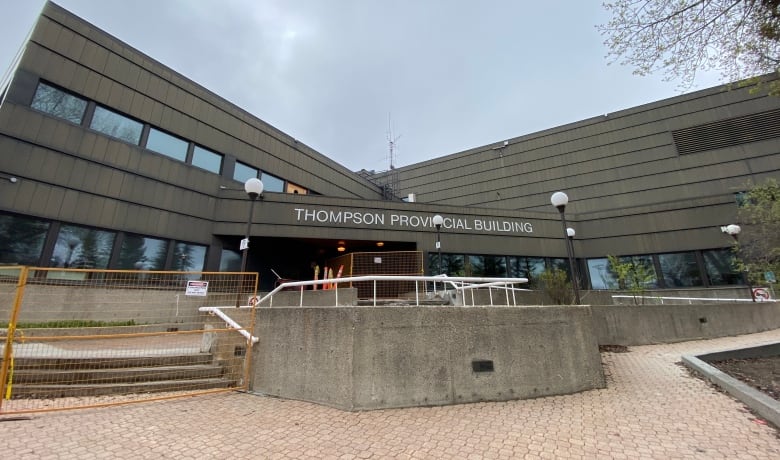 A gray building that says Thompson Provincial building. 