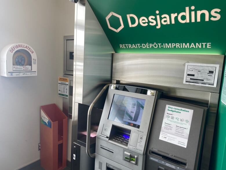 A defibrillator installed next to an ATM. 