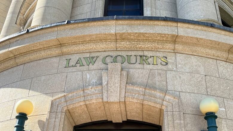 Close up of the exterior of a building with the words Law Courts on it.