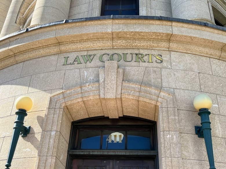 Close up of the exterior of a building with the words Law Courts on it.