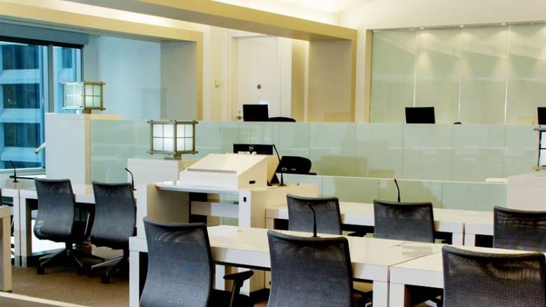 A courtroom with chairs and tables overlooking downtown Calgary. 