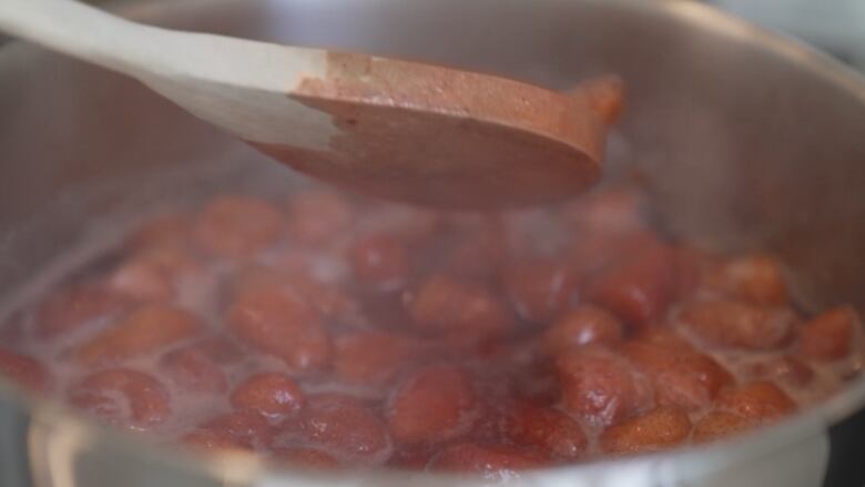 A pot of strawberries being cooked