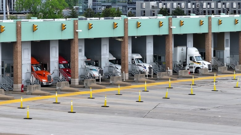 Trucks are shown going through customs at the Ambassador Bridge.