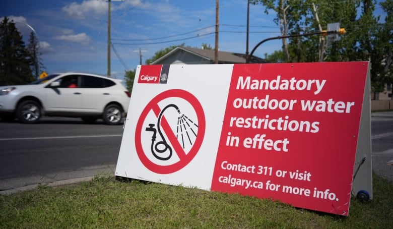 a sandwich board sign on green grass reads 