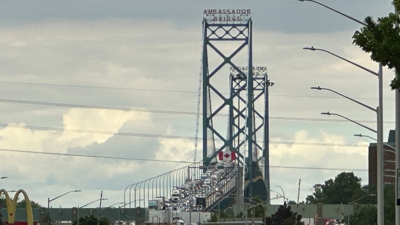 Trucks lined up along a bridge