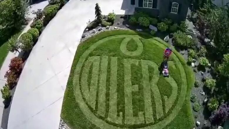 An overhead shot of an Oilers logo mowed into a lawn.