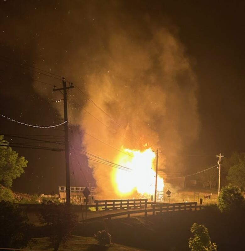 A photo taken in the middle of the night shows a sawmill on fire.