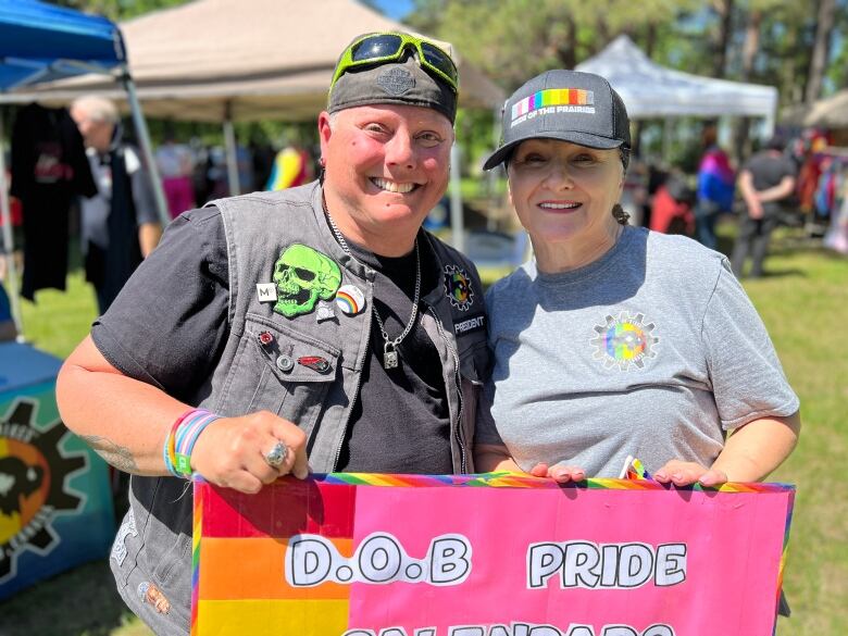 Two people holding a sign