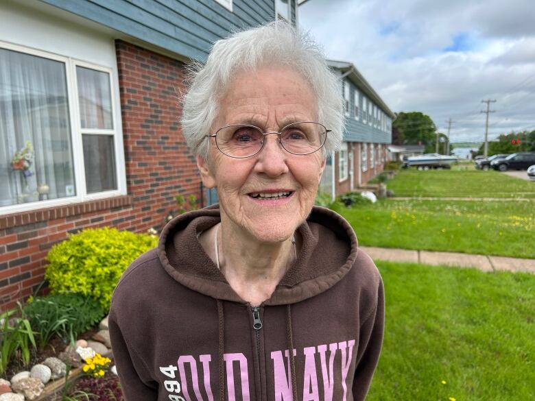 Woman with grey hair wearing Old Navy hoodie.