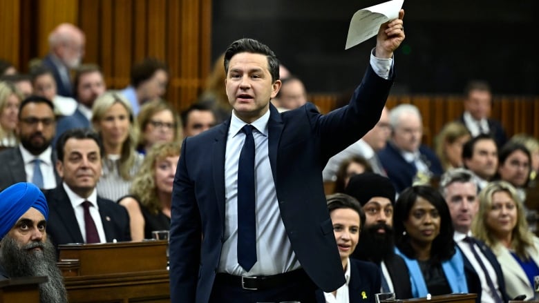 Conservative Leader Pierre Poilievre waves a document in the air as he rises during Question Period in the House of Commons on Parliament Hill in Ottawa.