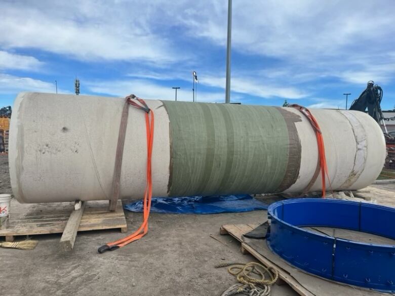 a large pipe standing on some heavy duty equipment.