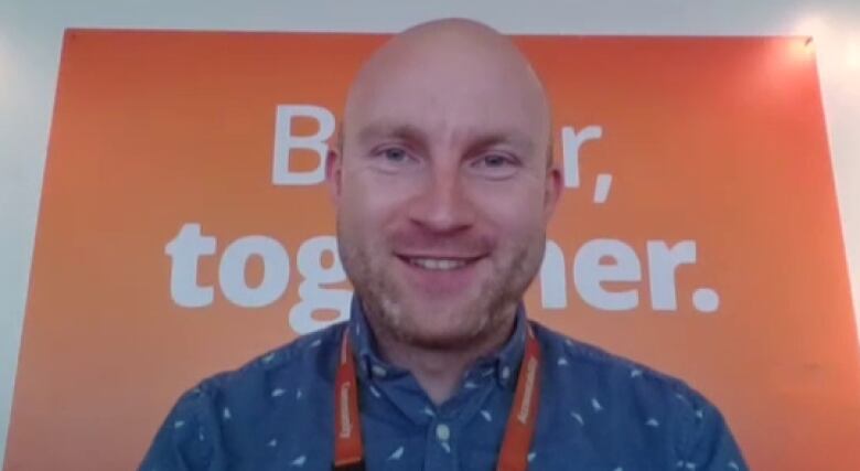 A man smiles at the camera on a Zoom call.