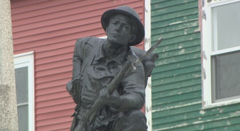 an image of a bronze statue of a soldier with his rifle