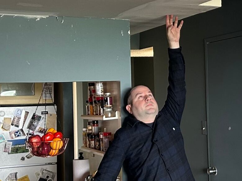 Robbie James at the entrance to his living room. His landlord, TCHC, won permission to lower his ceiling to less than 7 ft. in order to expand the ductwork necessary for his new heat pump - an addition that he says was unnecessary. 