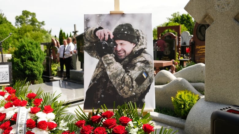 A portrait of Captain Arsen Fedosenko is displayed at his burial at Baikove cemetery on June 13. He was working as a photographer in the Kharkiv region when he was killed by a Russian glide bomb on June 10. 