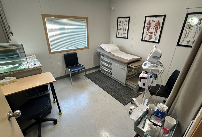 A room with a patient examination bed and other medical equipment.