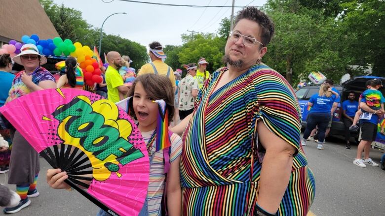 Two people in colourful outfits. 