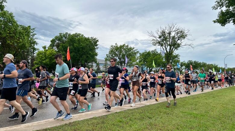 A group of runners head down a path.