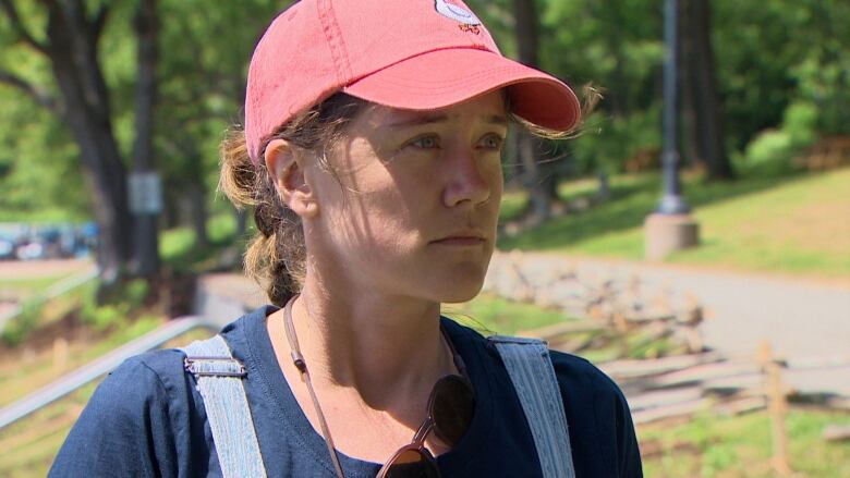 A woman wearing a pink hat and coveralls is shown at the installation site.