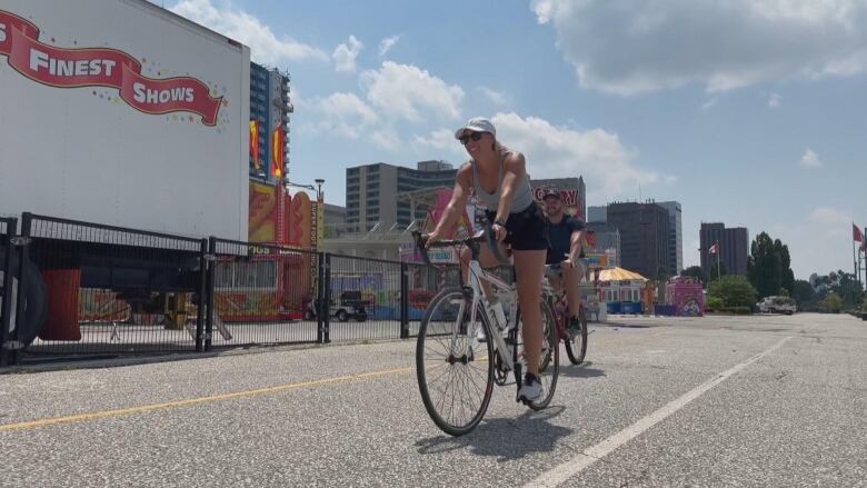 A woman rides a bicycle.