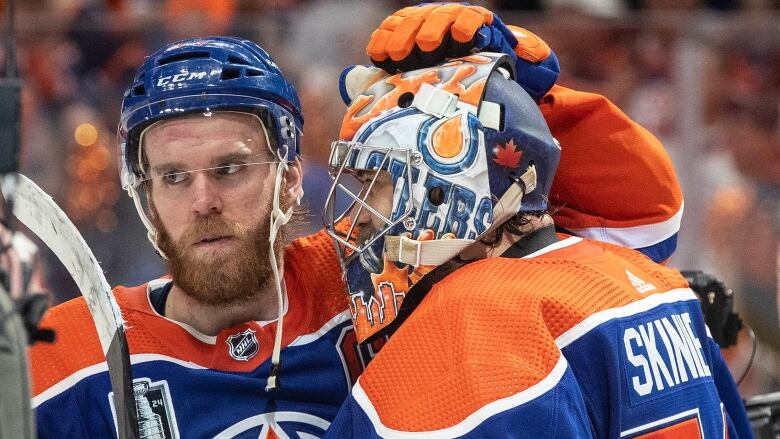 Two hockey players celebrate.