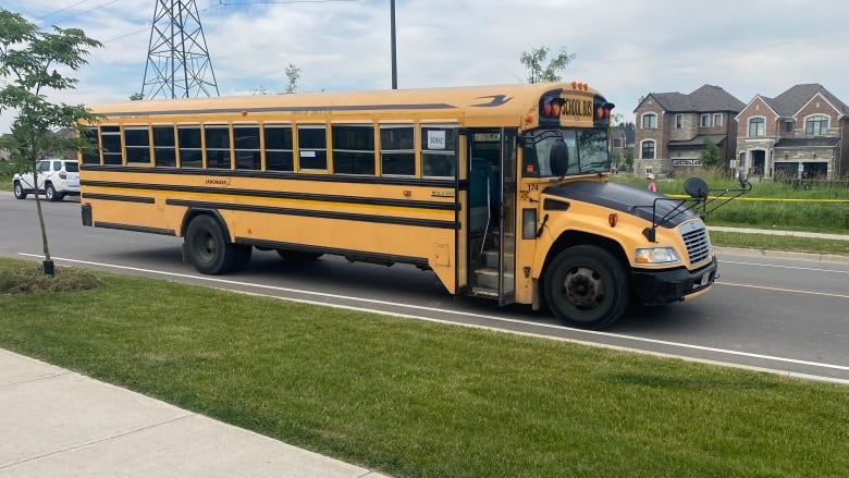 The school bus involved in a fatal collision with a six-year-old boy is parked in the street.