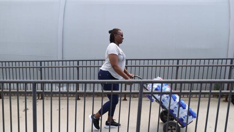 A woman drops off water