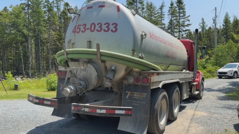 The back of a sewage truck is shown.