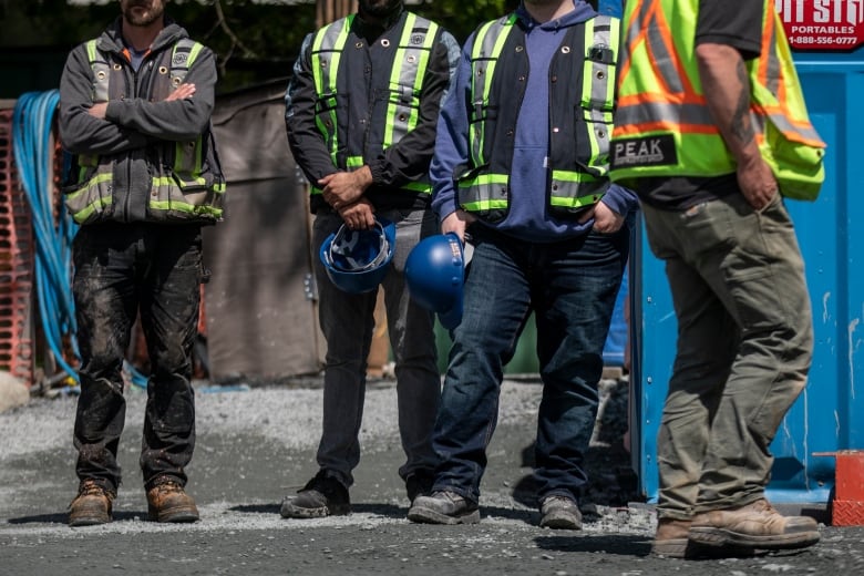 Construction workers are pictured during an affordable housing press conference in Vancouver, B.C.