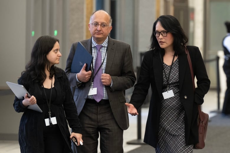 Jenny Kwan, the NDP MP for Vancouver East speaks with counsel Mani Kakkar and Sujit Choudhry during a break at the Public Inquiry Into Foreign Interference in Federal Electoral Processes and Democratic Institutions, Wednesday, April 3, 2024 in Ottawa.  THE CANADIAN PRESS/Adrian Wyld