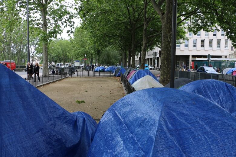 Blue tents line a courtyard.