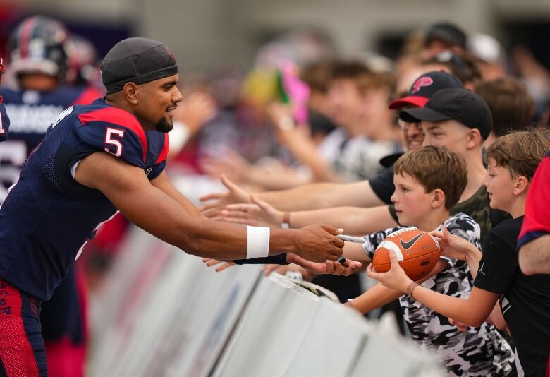 Football player giving five to fans