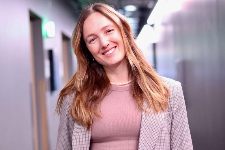 A woman smiles for a photo