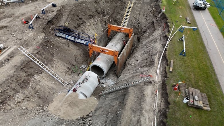 An overhead drone shot of a water main pipe being repaired.