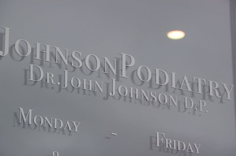 The sign on the glass door for Johnson Podiatry in Stratford.