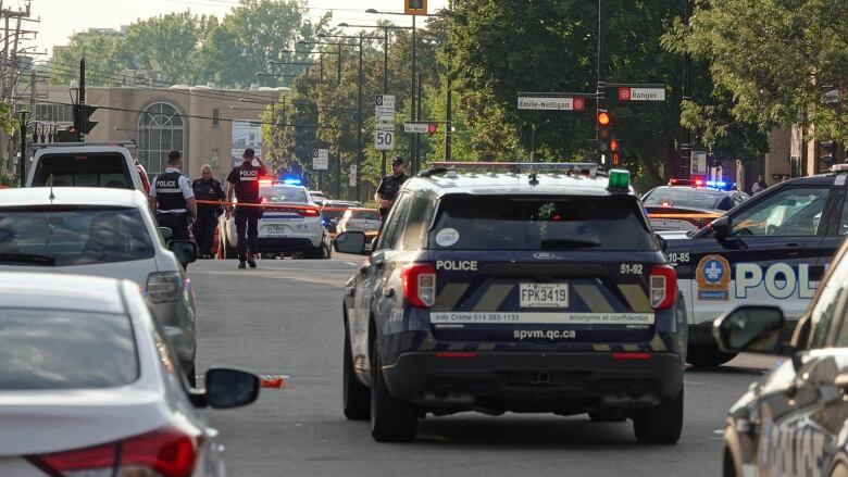 Police cars parked at an intersection.