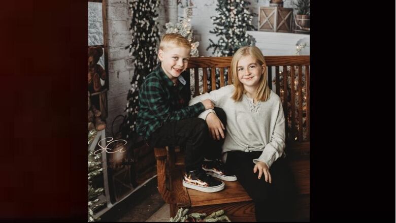 Two children in a Christmas setting.