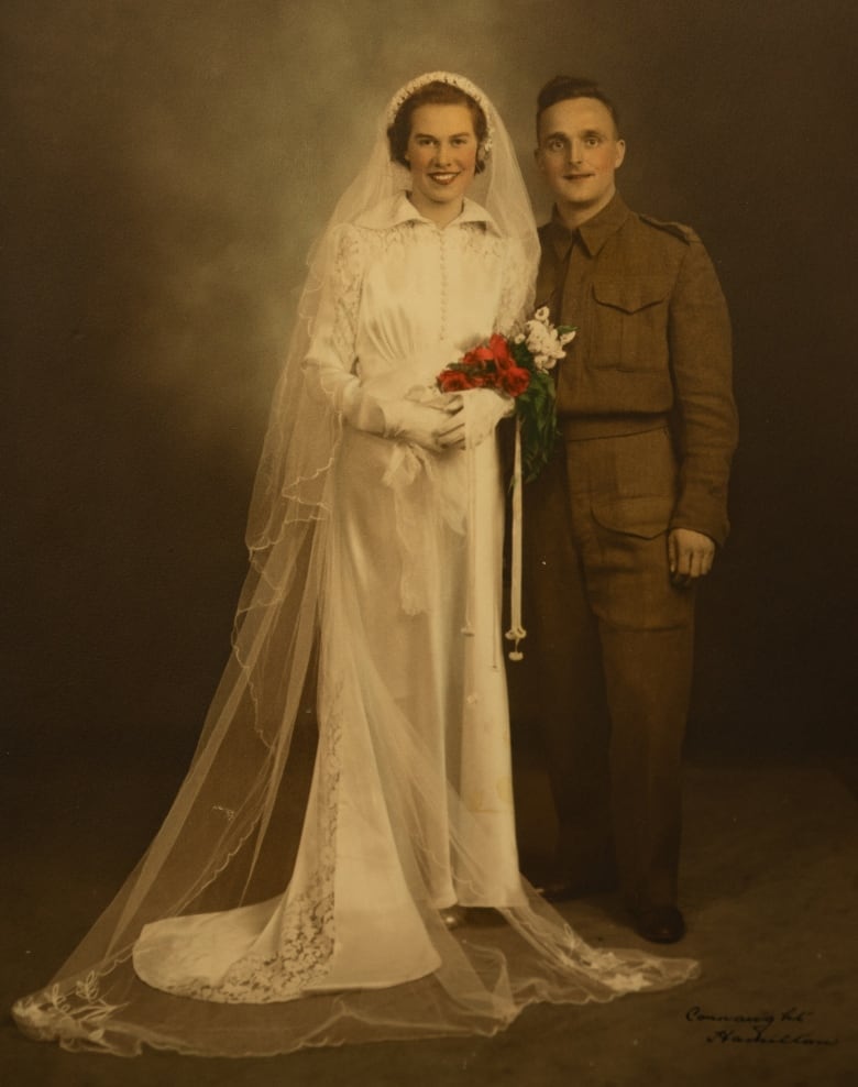 A copy photo of Margaret Friend's husband, George Edward Friend, on their wedding day in 1941. It is an older picture of a bride and groom, with the groom wearing military clothes.