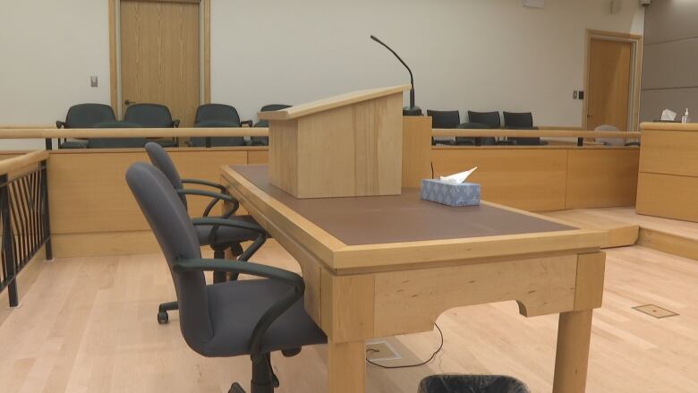 desk and chair area in court room, often used by lawyers and participants. 