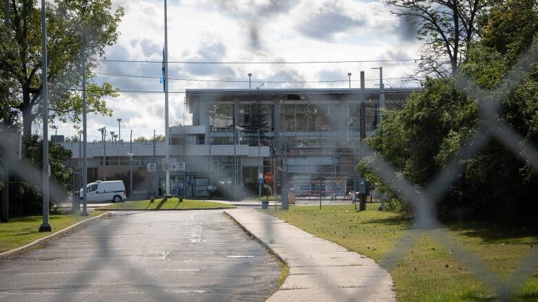 A jail is seen from behind a fence.