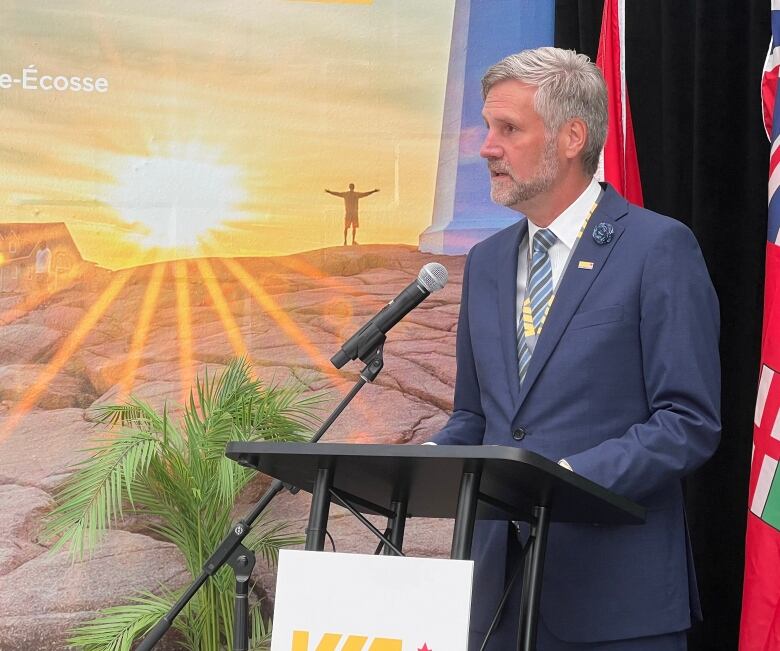 A man speaks at a podium