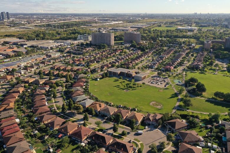 Aerial view of a school and the houses in the surrounding neighbourhood. 