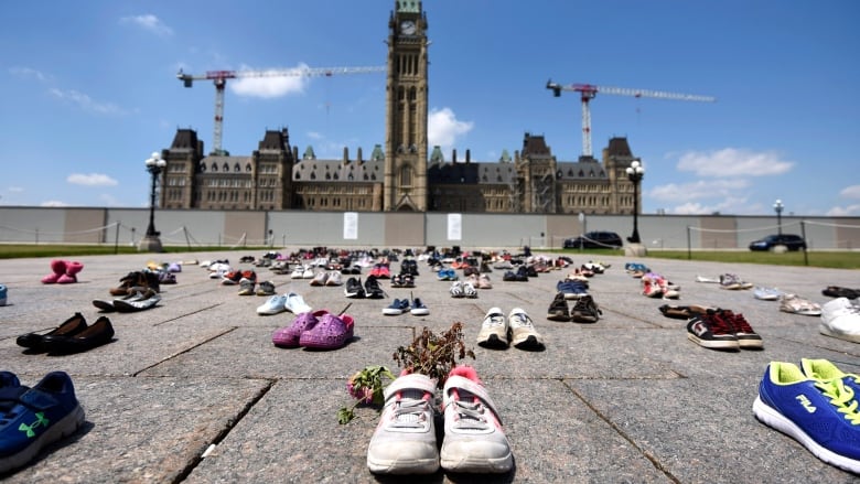 Dried flowers rest inside a pair of child's shoes at a memorial for children who died at the former Kamloops Indian Residential School in B.C.